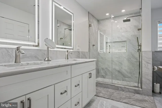 a bathroom with a shower sink and mirror