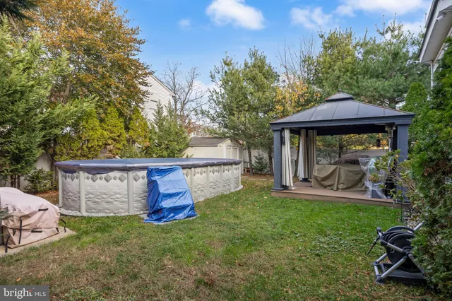 a view of a deck with a bench and floor to ceiling window