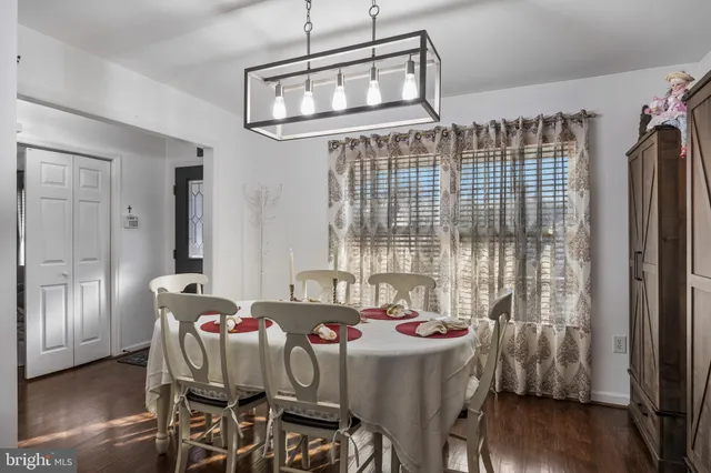 a dining room with furniture and wooden floor