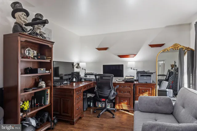 a view of a livingroom with workspace and a window
