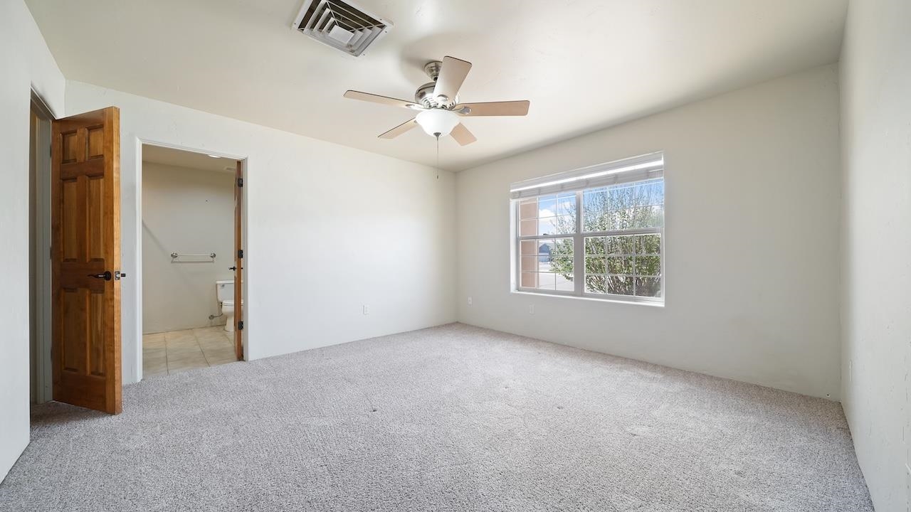 1296 Santa Fe Circle Fruita, CO 81521 - Photo 12 of 22 an empty room with fan and windows