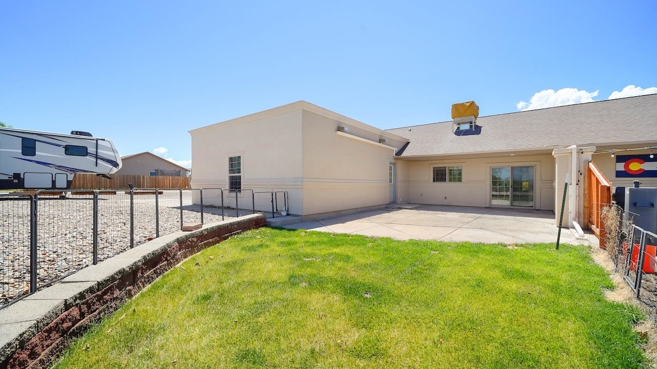 1296 Santa Fe Circle Fruita, CO 81521 - Photo 16 of 22 a view of a house with a backyard