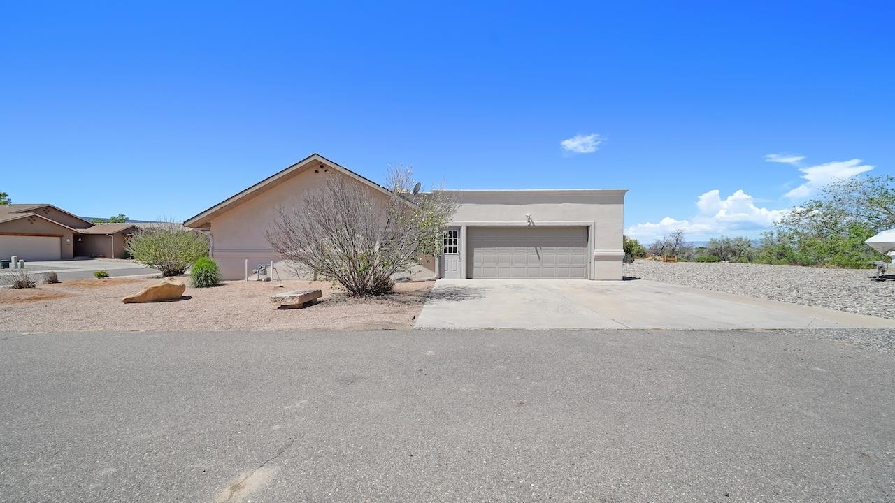 1296 Santa Fe Circle Fruita, CO 81521 - Photo 17 of 22 a view of a house with a yard and garage