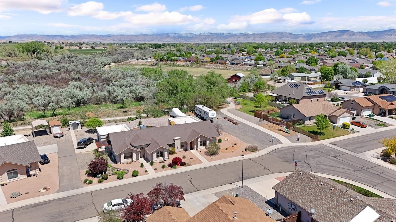 1296 Santa Fe Circle Fruita, CO 81521 - Photo 19 of 22 a view of a city with lots of residential buildings ocean and mountain view in back