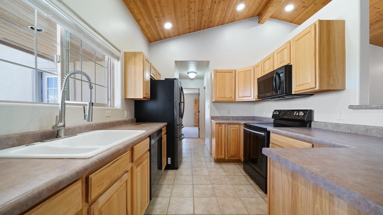 1296 Santa Fe Circle Fruita, CO 81521 - Photo 5 of 22 a kitchen with a sink stove and refrigerator