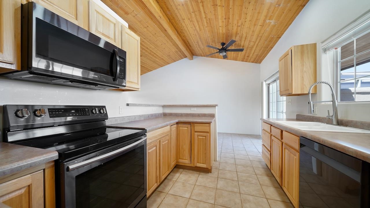 1296 Santa Fe Circle Fruita, CO 81521 - Photo 6 of 22 a kitchen with a stove and a microwave