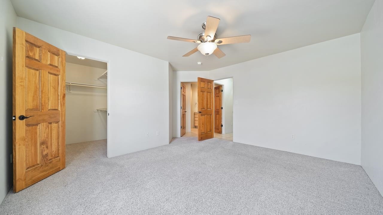 1296 Santa Fe Circle Fruita, CO 81521 - Photo 8 of 22 a view of an empty room with a chandelier fan
