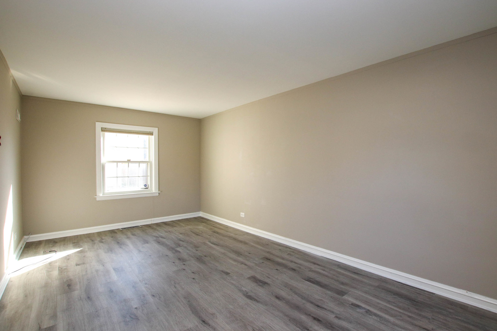5815 North Canfield Avenue Chicago, IL 60631 - Photo 13 of 28 a view of an empty room with wooden floor and a window