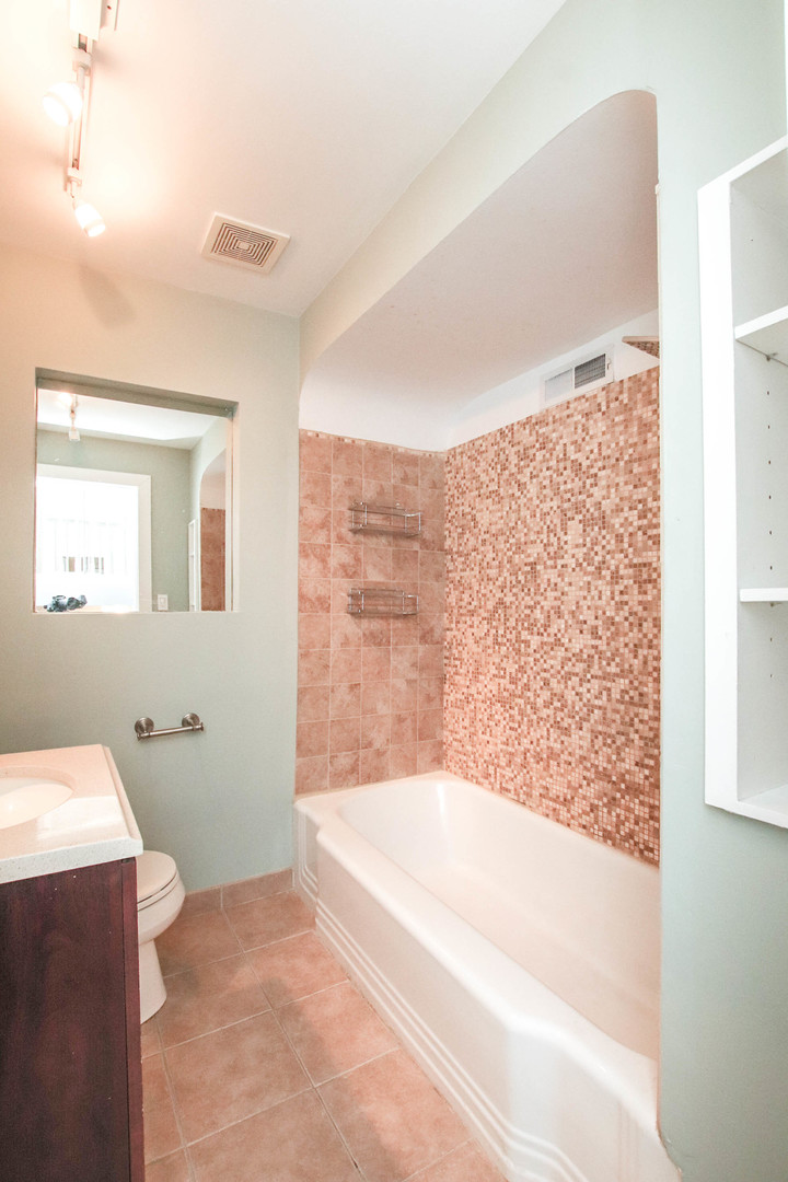 5815 North Canfield Avenue Chicago, IL 60631 - Photo 16 of 28 a spacious bathroom with a bathtub and a shower
