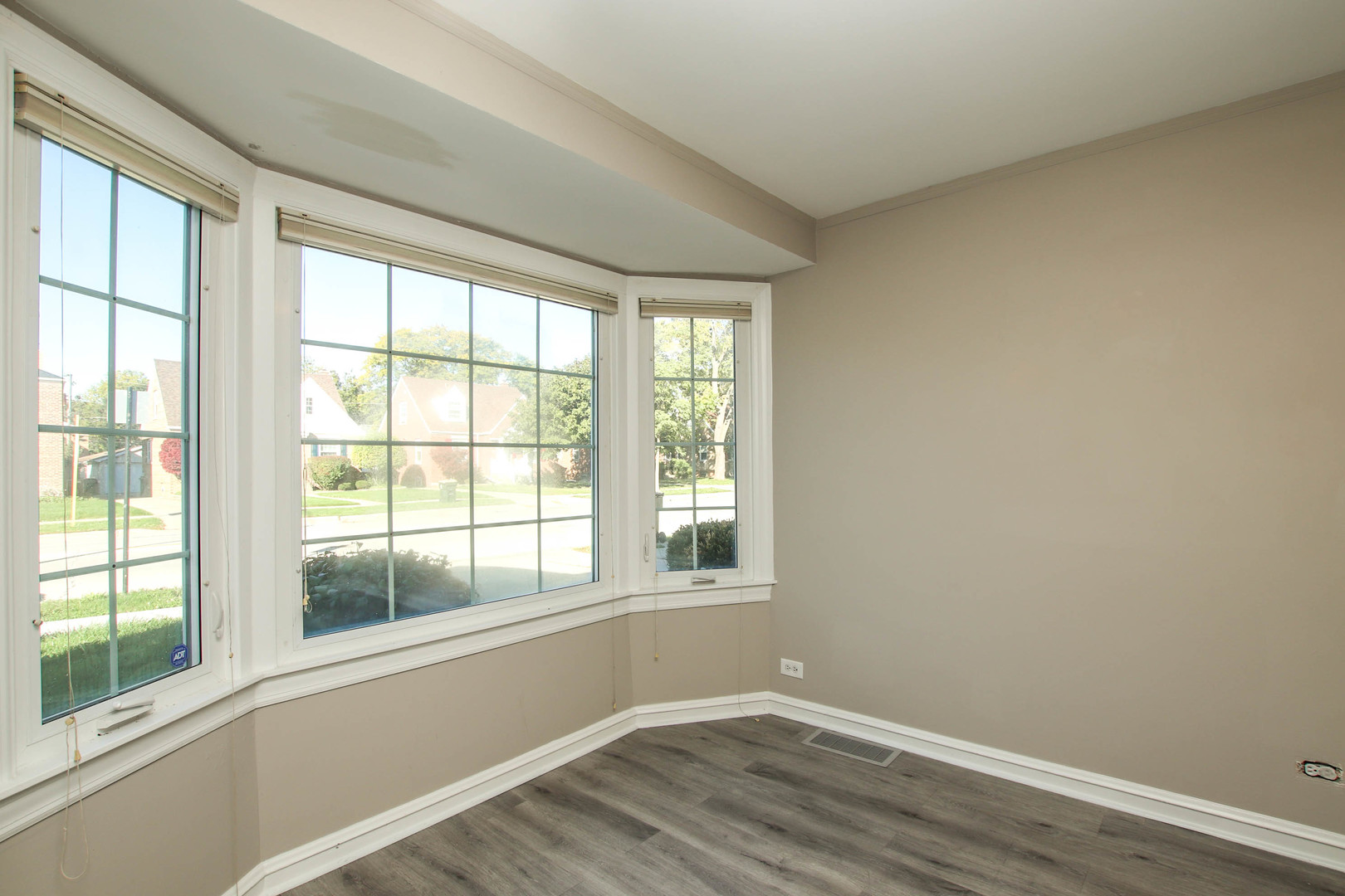 5815 North Canfield Avenue Chicago, IL 60631 - Photo 2 of 28 a view of an empty room with wooden floor and a window