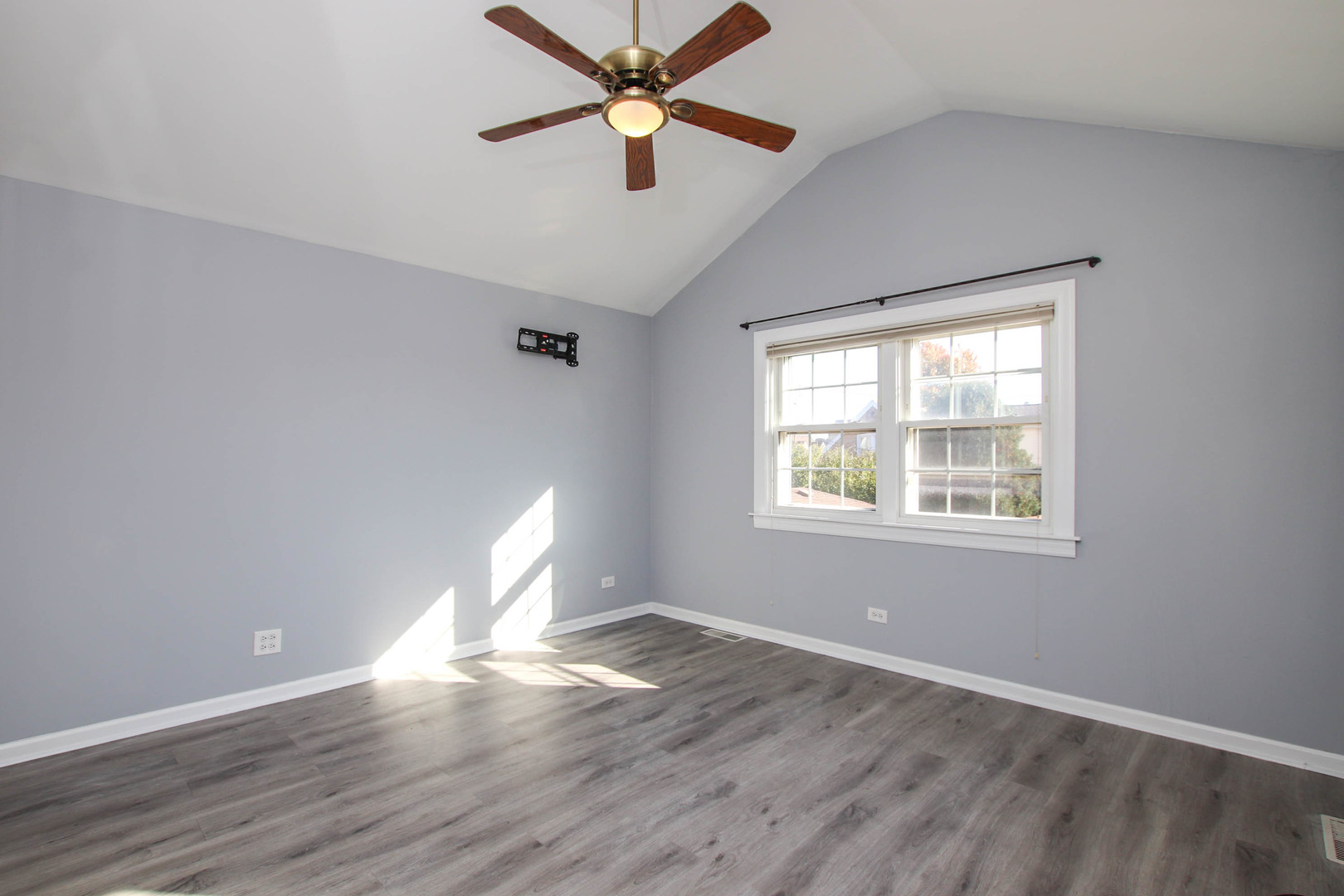 5815 North Canfield Avenue Chicago, IL 60631 - Photo 4 of 28 an empty room with wooden floor chandelier fan and windows