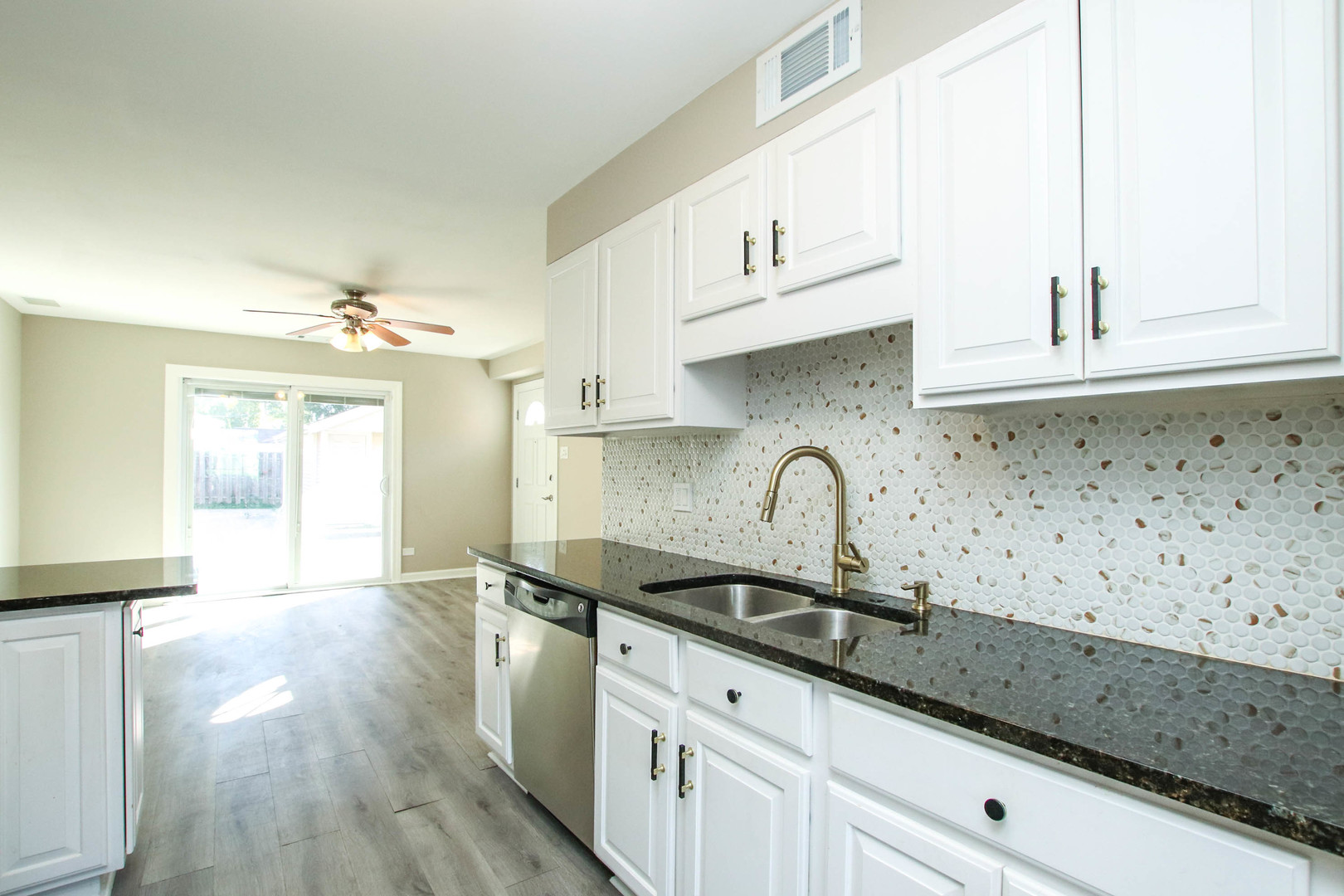 5815 North Canfield Avenue Chicago, IL 60631 - Photo 7 of 28 a kitchen with granite countertop white cabinets and a sink