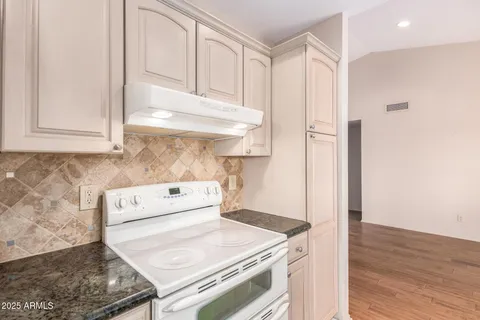 a kitchen with a stove and a refrigerator