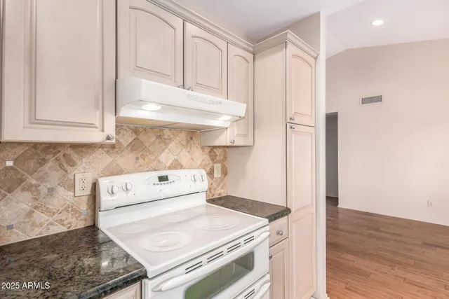 a kitchen with a stove and a refrigerator