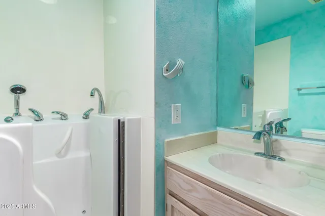 a bathroom with a sink and a large mirror