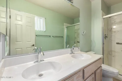 a bathroom with a sink and a mirror with toilet