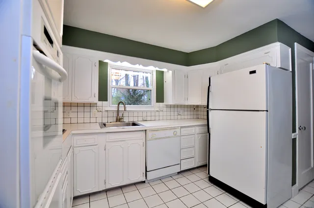 a kitchen with a sink stove and microwave