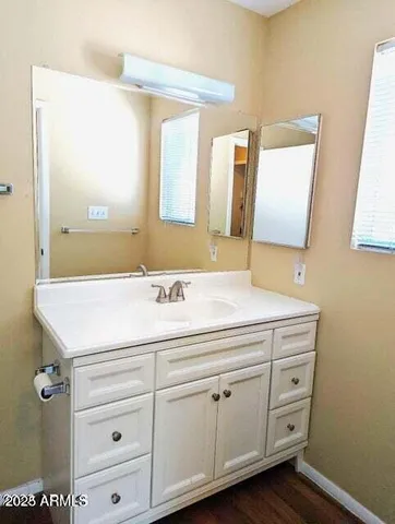 a bathroom with a granite countertop sink and a mirror