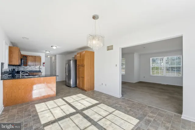 a view of a kitchen with a sink and a refrigerator