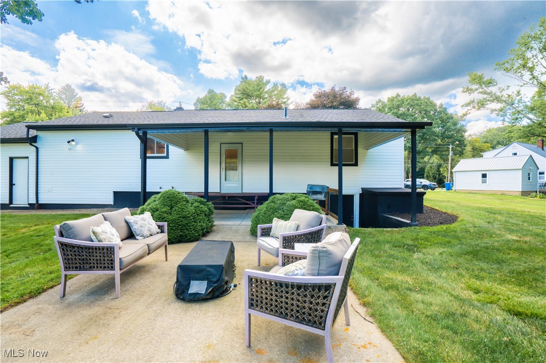 3525 Mayfair Road Akron, OH 44312 - Photo 10 of 31 Rear view of house with an outdoor living space and a lawn