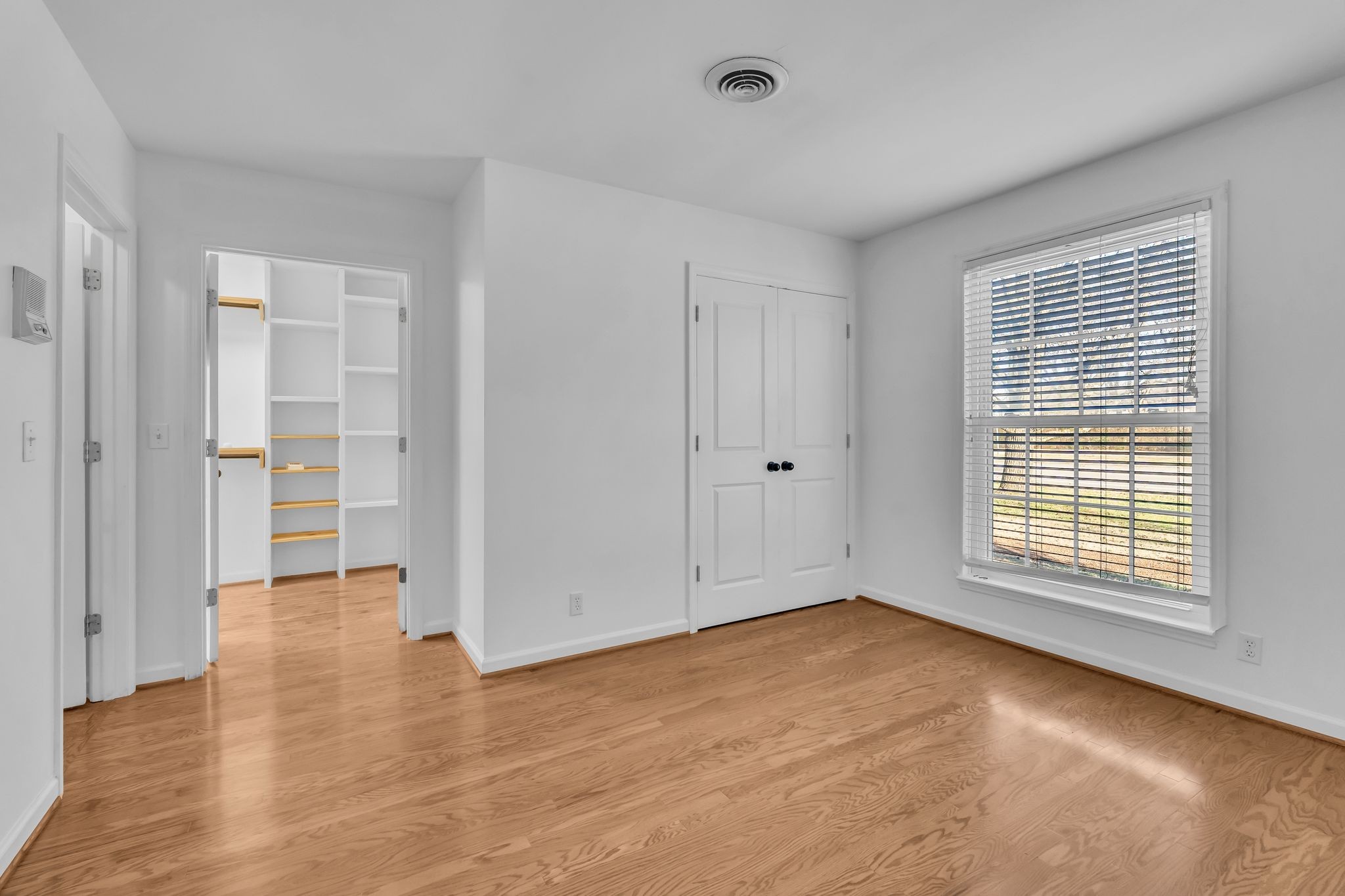 8300 Sawyer Brown Road, Unit M301 Nashville, TN 37221 - Photo 23 of 36 an empty room with wooden floor and windows