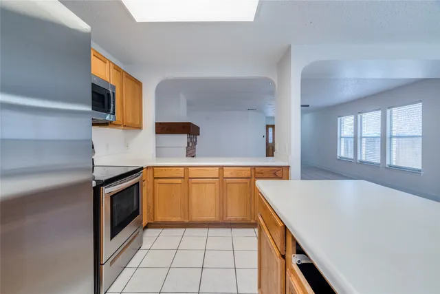a kitchen with stainless steel appliances granite countertop a sink and a stove top oven