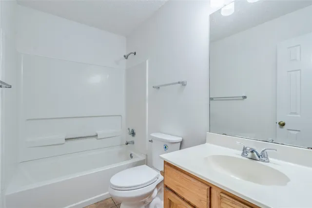 a bathroom with a sink toilet vanity and shower