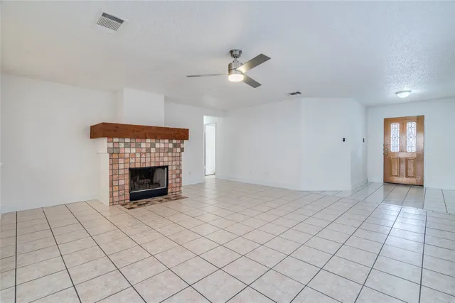 a view of an empty room and fire place