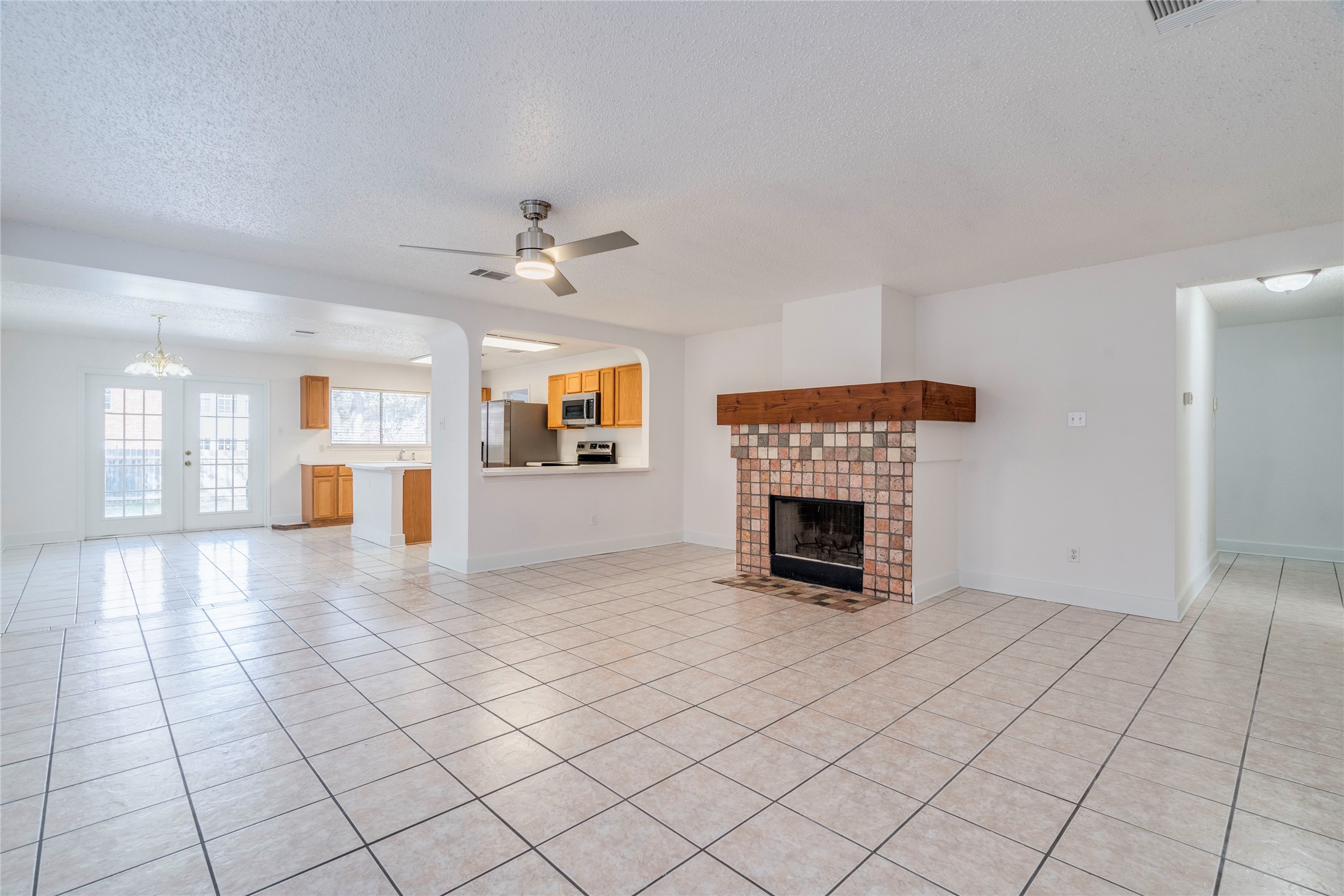 2013 Jasper Lane Cedar Park, TX 78613 - Photo 4 of 25 a view of a livingroom with a fireplace a chandelier and windows