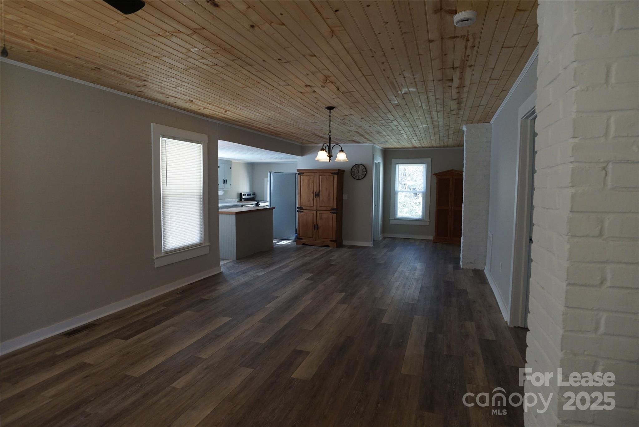 146 Fairway Avenue Hudson, NC 28638 - Photo 2 of 9 a view of a hallway with wooden floor and a kitchen space