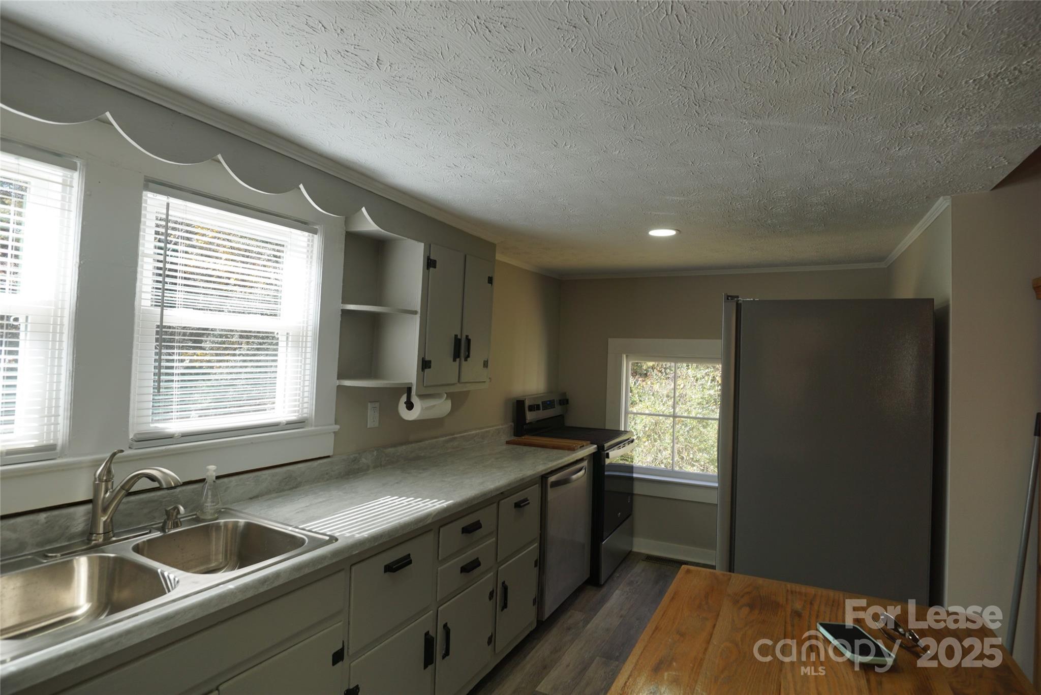 146 Fairway Avenue Hudson, NC 28638 - Photo 3 of 9 a kitchen with granite countertop a sink stove and cabinets