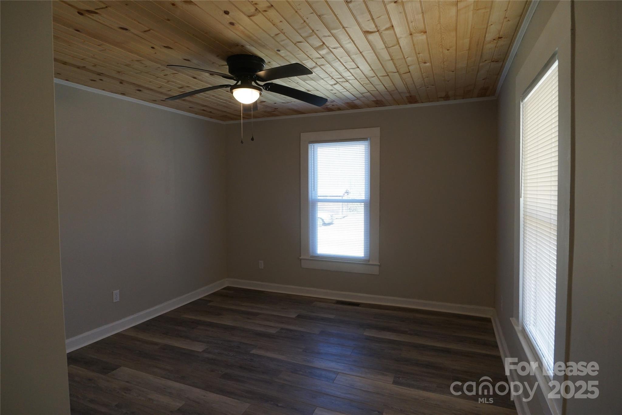 146 Fairway Avenue Hudson, NC 28638 - Photo 4 of 9 a view of an empty room with wooden floor and a window