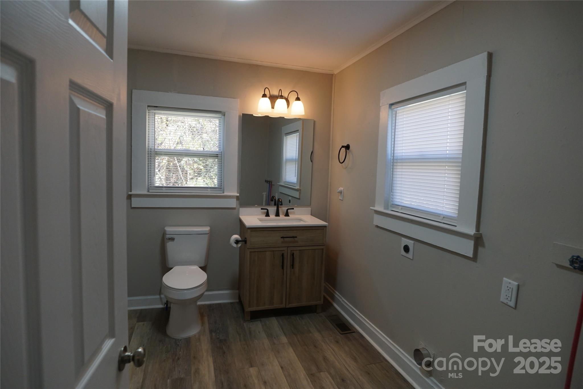 146 Fairway Avenue Hudson, NC 28638 - Photo 8 of 9 a bathroom with a sink toilet a mirror and window