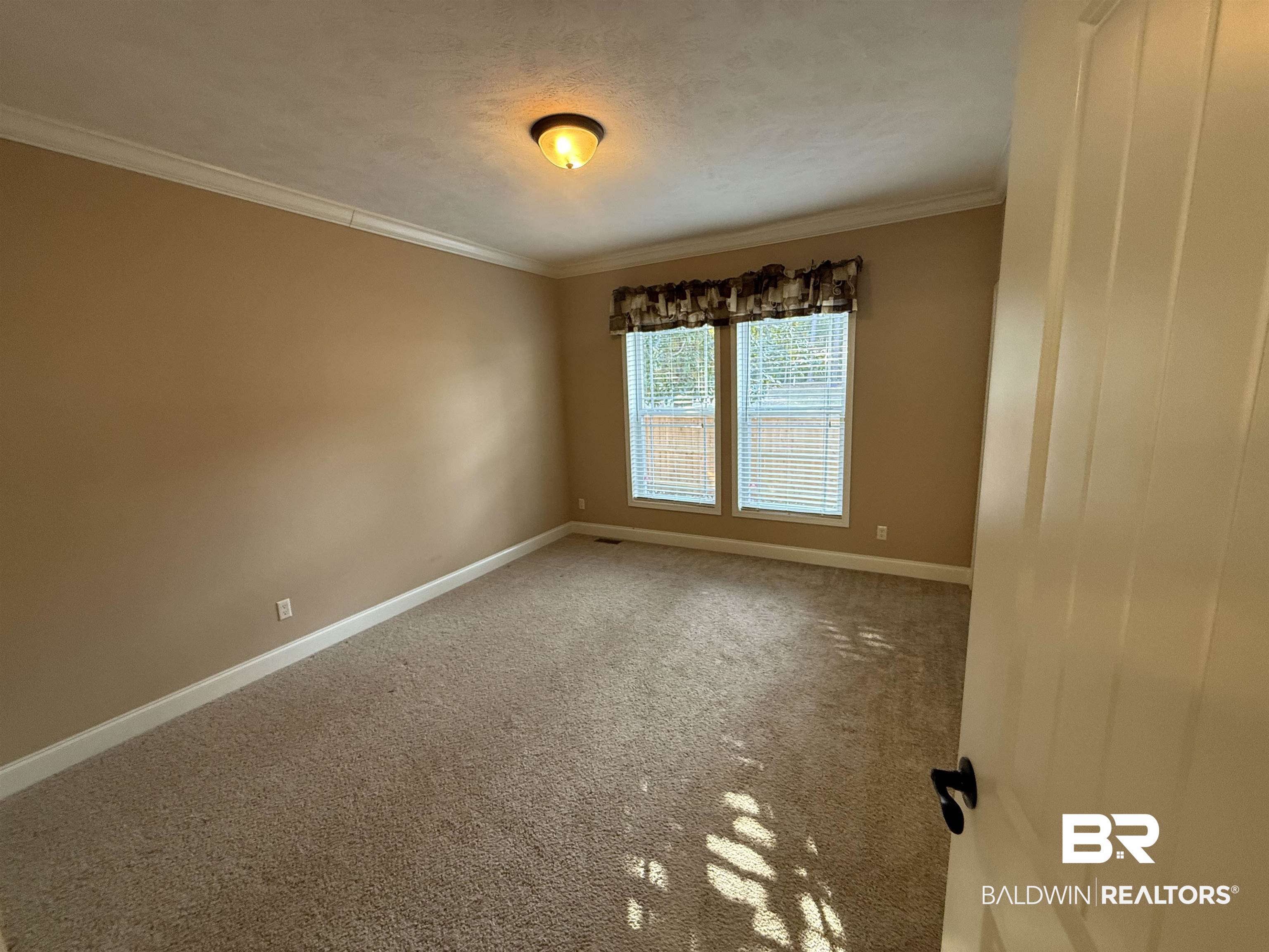 1274 Caney Loop Lillian, AL 36549 - Photo 12 of 19 Unfurnished room with ornamental molding, carpet floors, and a textured ceiling