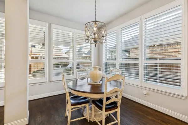 a view of a dining room with furniture windows and wooden floor