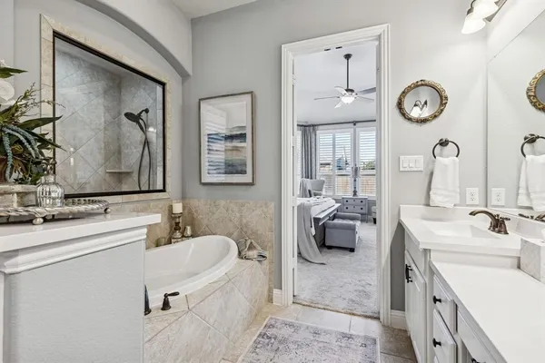 a en suite bathroom with a double vanity sink and a mirror
