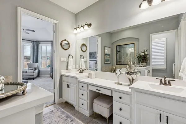 a spacious bathroom with a double vanity sink mirror and