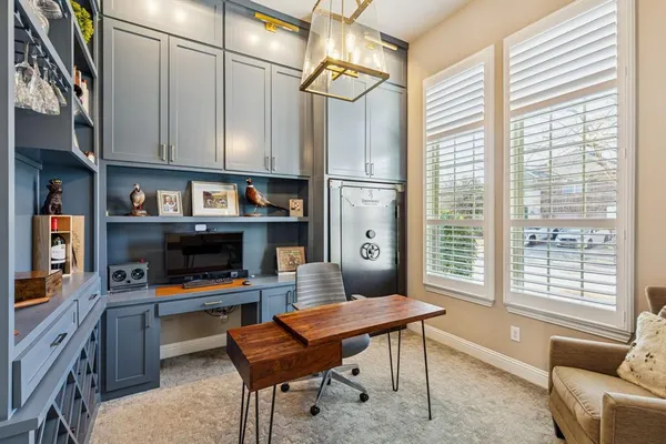 a reading room with furniture a rug and a window