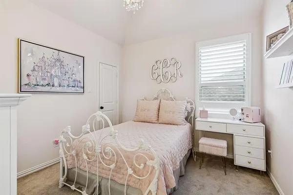 a bedroom with a bed and a desk