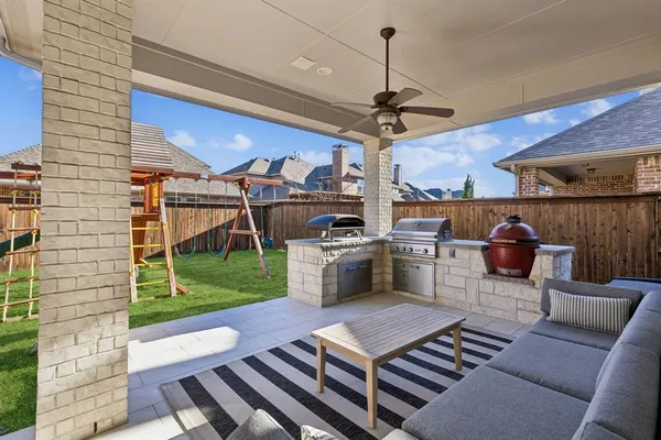 a view of a patio with a table chairs and a garden