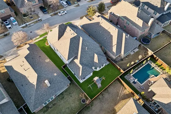 an aerial view of a house with a yard