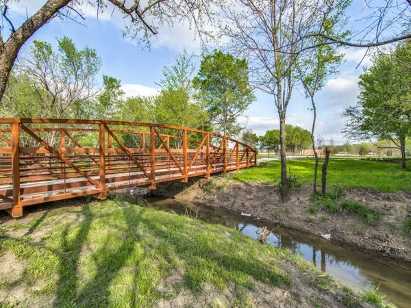 a living room with furniture a large mirror and gym equipment
