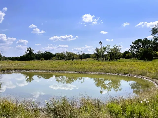 a view of a lake with a house in the background
