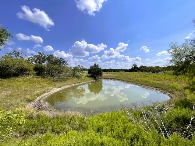 a view of a lake with sunset