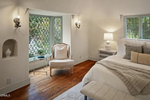 a bedroom with a bed and a chair