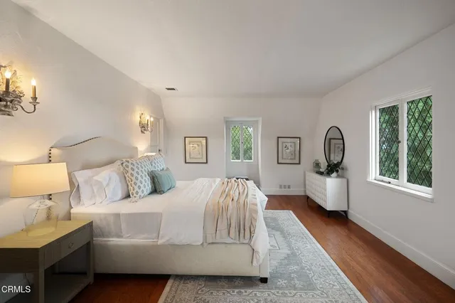 a bedroom with a large bed and a window