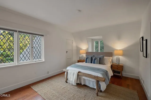 a bedroom with a bed lamp and a window