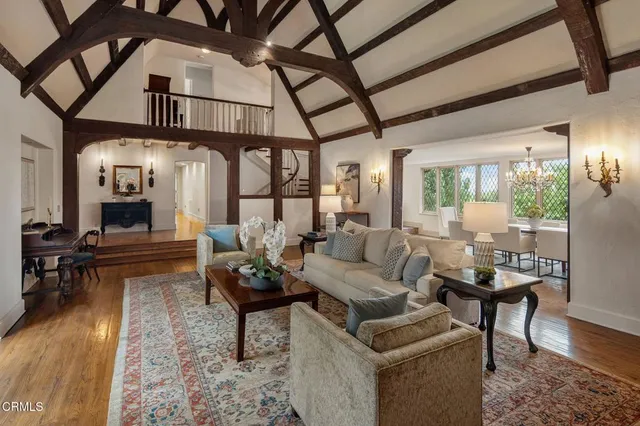a living room with furniture and a chandelier
