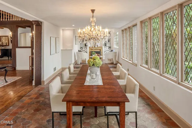 a view of a dining room with furniture and chandelier