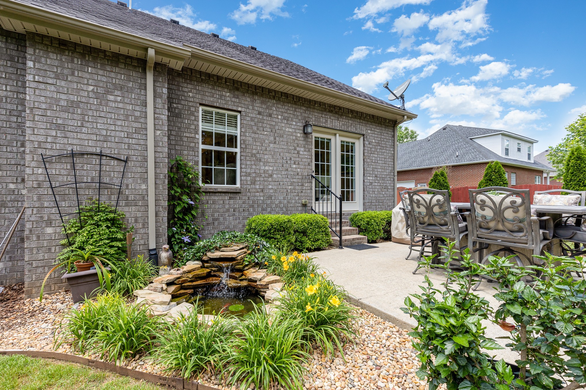 257 Conquest Road Murfreesboro, TN 37128 - Photo 3 of 44 a backyard of a house with a garden and outdoor seating